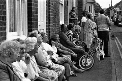 Residents of Baydon House With chairs outside, thoroughly enjoying the Carnival Parade.