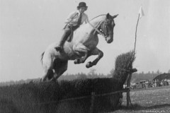 Pauline Bracey jumping a hurdle