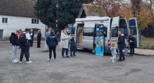 Minibus with banners parked on market square